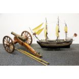 A brass and wood model canon, L. 46cm. and a plastic model of HMS Victory.