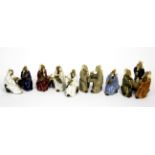 A group of Chinese hand made glazed pottery figures of scholars, highest, 7cm.