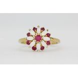 A hallmarked 9ct yellow gold ring set with marquise cabochon cut opals and rubies, (O.5).