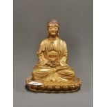 A Chinese bronze figure of a seated Buddha, H. 22cm.