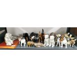 A group of wood, ceramic and other animal figures.