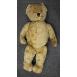 A large English straw field articulated teddy bear, H. 95cm.