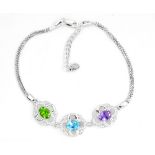 A 925 silver bracelet set with oval cut amethyst, blue topaz and peridot, L. 17cm.