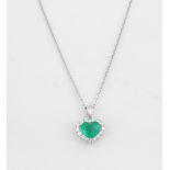 A 18ct white gold emerald (2.2ct) and diamond (0.58ct) set pendant on an 18ct white gold chain,