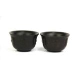A pair of carved horn tea bowls, Dia. 8cm. H. 5cm.