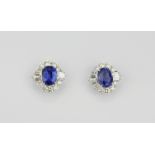 A pair of 18ct white gold sapphire (4.61ct) and diamond (1.62ct) set cluster earrings.