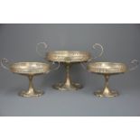 An unusual set of three hallmarked silver presentation comports, tallest. 20cm. Central comport with