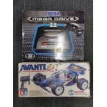 A boxed Sega Mega Drive II together with a radio controlled racing car.