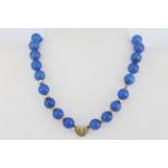 A 9ct yellow gold (stamped 9k) gold and polished chalcedony bead necklace, L. 18cm.