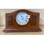 An Edwardian inlaid mahogany mantel clock, H. 15cm. Appears to be in working order.