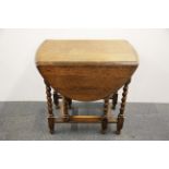 An oak barley twist drop leaf tea table, W. 76cm x 105cm.