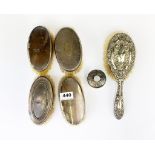 A group of hallmarked silver back dressing table brushes and hair tidy.
