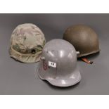 A group of three military helmets.