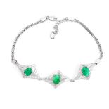 A 925 silver bracelet set with oval cut emeralds and white stones, L. 17cm.