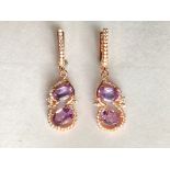 A pair of 925 silver rose gold gilt drop earrings set with oval cut amethysts and white stones.