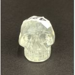 A carved rock crystal skull, H. 4cm.