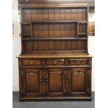 An oak antique style three drawer dresser, W. 135cm. H. 187cm.