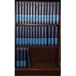 A 1999 set of Encyclopaedia Britannica together with a mahogany bookcase.