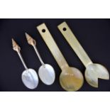 A pair of shell, white metal and mother of pearl spoons and a pair of carved horn salad servers.