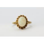 A hallmarked 9ct yellow gold ring set with a cabochon cut opal, (O.5).