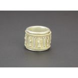A Chinese white metal articulated thumb ring, W. 2.2cm, Dia. 3cm.