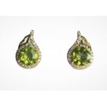 A pair of 925 silver silver gilt earrings set with round cut peridots and white stones, L. 1cm.