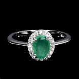 A 925 silver emerald and white stone set cluster ring, (M).