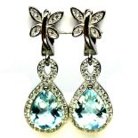 A pair of 925 silver drop earrings set with faceted cut blue topaz and white stones, L. 6.7cm.