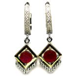 A pair of 925 silver gilt drop earrings set with round cut rubies and white stones, L. 3.2cm.