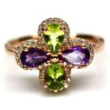 A 925 silver rose gold gilt ring set with pear cut peridots and amethysts, (P).