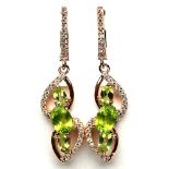 A pair of 925 silver rose gold gilt drop earrrings set with oval ctu peridots and white stones, L.