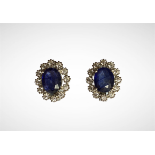 A pair of 925 silver cluster earrings set with oval cut blue topaz surrounded by white stones, L.