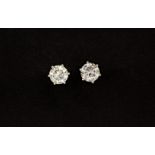 A pair of 18ct white gold stud earrings, each set with a large brilliant cut diamond, approx. 4.05ct
