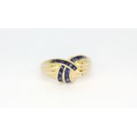 A 14ct yellow gold (stamped 14k) ring set with square cut sapphires, (Q).