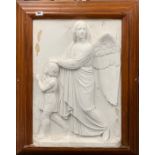 A large pine framed plaster relief of an angel with a child with inset brass plaque on the reverse