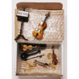 A quantity of dolls house musical instruments.