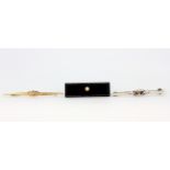 A yellow metal (tested minimum 9ct gold) stone set brooch with an onyx and pearl set brooch and a