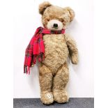 A large straw filled articulated teddy bear, H. 95cm.
