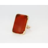 A 14ct yellow gold (stamped 14k) ring set with a large cabochon cut cornelian, (K.5).