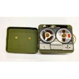 A vintage portable reel-to-reel tape recorder.