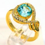 A matching 925 silver gilt ring set with a round cut blue topaz and white stones, (O).