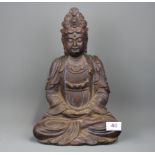 A Chinese carved wooden figure of a seated Guanyin, H. 34cm.
