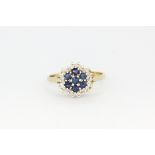 A hallmarked 9ct yellow gold sapphire and diamond set cluster ring, (K), approx. 1.8gr.