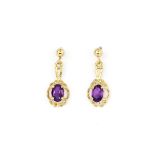 A pair of 9ct yellow gold (stamped 375) drop earrings set with oval cut amethysts, L. 1.8cm.