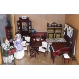 A quantity of good quality dolls house antique style furniture and two figures.