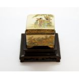 A small Japanese satsuma porcelain box and cover with purpose made wooden stand, box size 6.2 x 6.