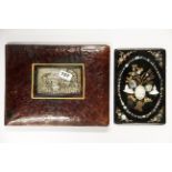 A white metal inset leather bound desk blotter together with a Victorian mother of pearl inset