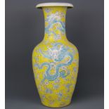 A Chinese hand enamelled porcelain vase with blue green dragons on yellow ground, six character mark