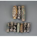 A quantity of Tibetan dzi beads, longest 7cm.