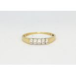 An 18ct yellow and white gold ring set with five brilliant cut diamonds, (P).